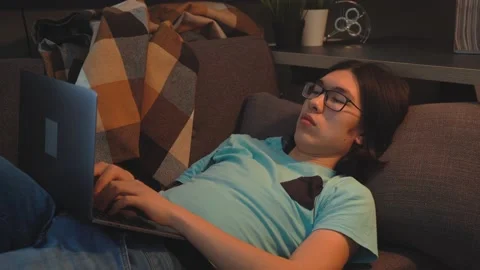 Asian Handsome  Man is Texting on Social Media on Laptop Stock Footage 148347314