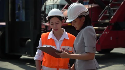 Asian harbor worker and manager  woman discussion and using clipboard checkin Stock Footage 157715807