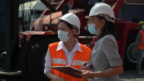 Asian harbor worker and manager  woman wearing face mask discussion and using Stock Footage 157715883