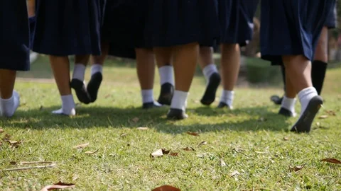 The Asian high school students in white uniform are walking through the lawn,  Stock Footage 102424742