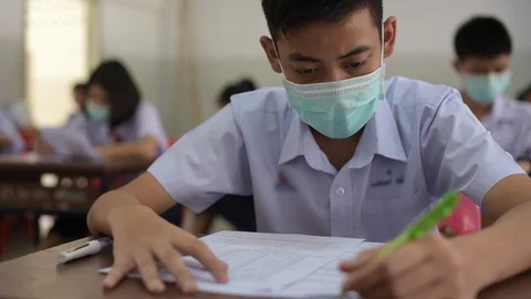 Asian high school students in a white school uniform wearing the masks Stock Footage 125764650
