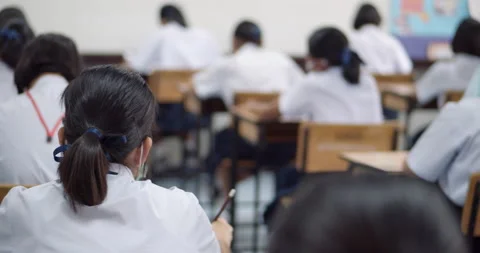 Asian high school students in white school uniform are serious and tired of exam Stock Footage 149354966