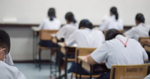 Asian high school students in white school uniform are serious and tired of exam Stock Footage 149384237