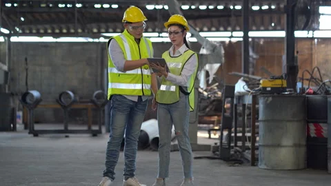 Asian industrial Engineer manager man discussion with mechanic worker woman.. Stock Footage 246103151
