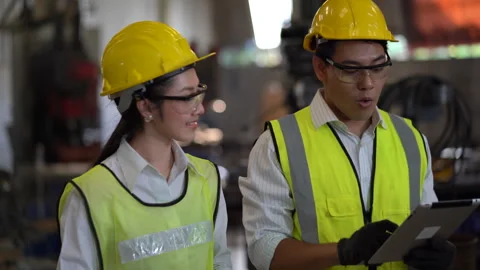 Asian industrial Engineer manager man using tablet walking and talking to m.. Stock Footage 246107127