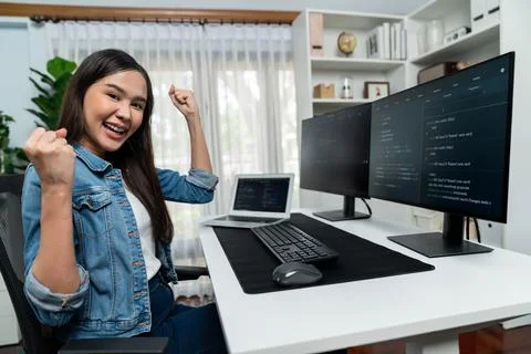Asian IT developer creating raising fist up with successful project. Stratagem. Foto stock