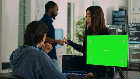 Asian IT engineers analyzing greenscreen on computer and coding database Stock Photos