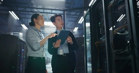 Asian IT Specialists Using Tablet Computer in Data Center Stock Footage 320000978