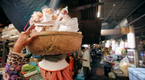 Asian keeps on her head a basket of food on the market Stock Footage 48784958