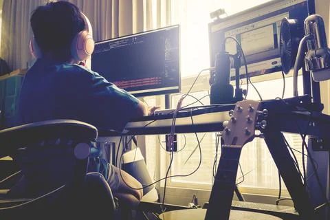 Asian kid is coding and scripting program on on his game streaming desktop co Stock Photos