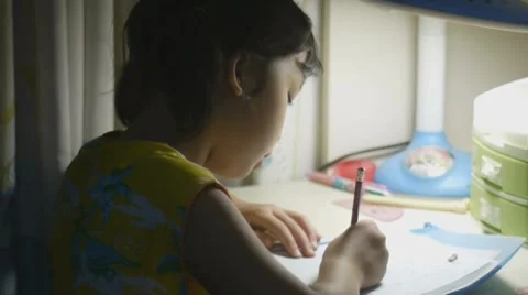 Asian kid doing homework Stock Footage 7757709