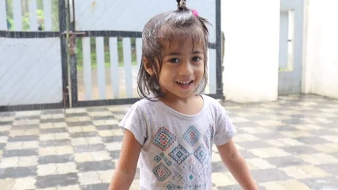 Asian Kid Jumping In the Rain Stock Footage 158907935