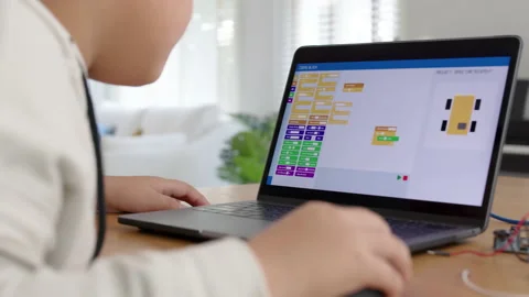 Asian kid make scratch robot car programming at home STEM study online Stock Footage 158440931
