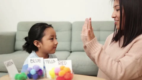 Asian kid playing didactic game with his mom at home - Montessori education Stock Footage 170508597