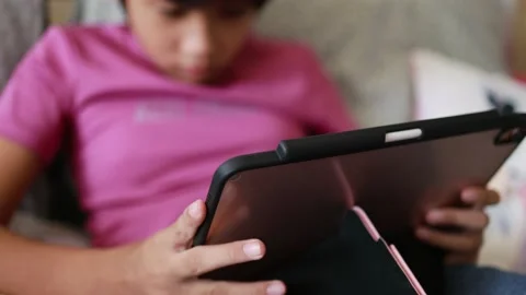 Asian kid playing game on digital tablet Stock Footage 167784797