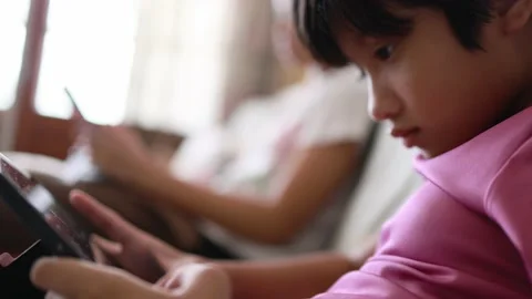 Asian kid playing game on digital tablet Stock Footage 167785672
