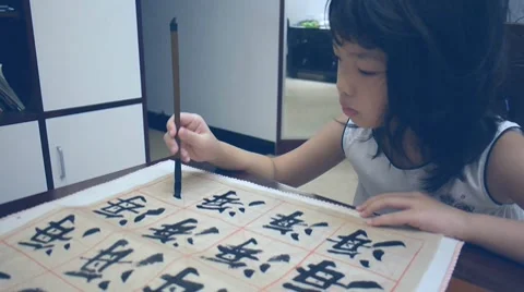 Asian kid writing Stock Footage 8557761