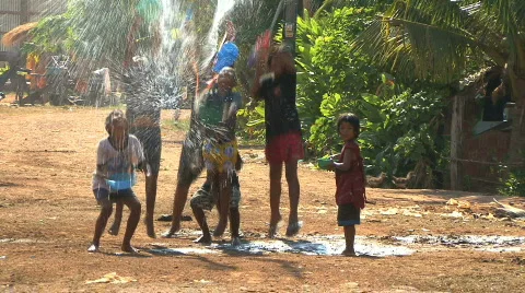 Asian Kids Playing With Water During Songkran On The Road In The Slums Stock Footage