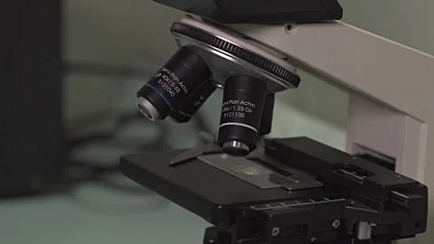 Asian Lab Tech with Microscope Stock Footage 248794977