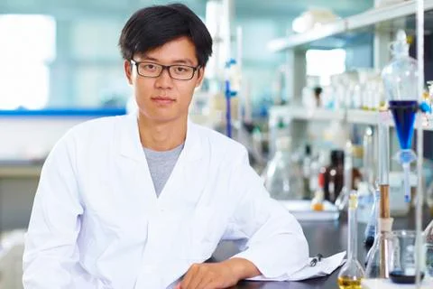 Asian Laboratory scientist working at lab with test tubes Stock Photos