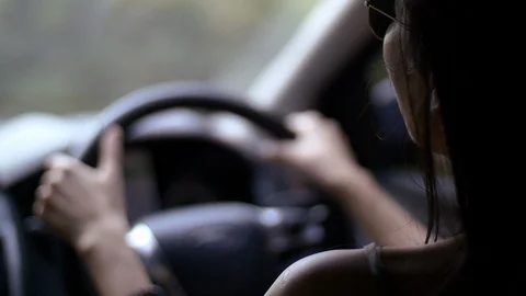  asian lady driving car camera shoot from back passenger Stock Footage 106076724