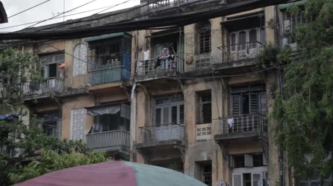 Asian lady  with Laundry on balcony of decrepit building (Yangon/Burma) Stock Footage 56632771