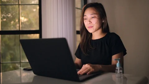 Asian lady working from home having soar throat rubbing the neck. Stay home and 스톡 동영상 128086366