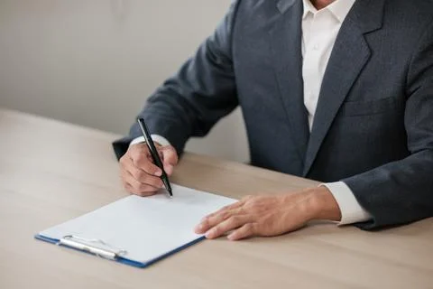 Asian lawyer man working on table office Writing a document, law and justice Stock Photos