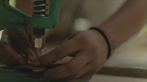 Asian leather smith, works with tools to make straps, slo-mo. Stock Footage 82329319