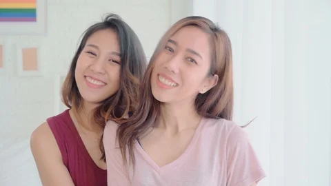 Asian lesbian couple smiling to camera while relax in her bedroom at home. Stock Footage 100609904