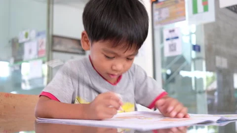 Asian little boy doing homework at home Stock Footage 163219518