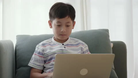 Asian little boy using computer laptop. Asia male learn online distance Stock Footage 166449325