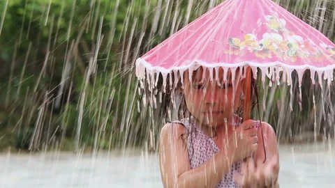 Asian little child girl wet in the rain ... | Stock Video 