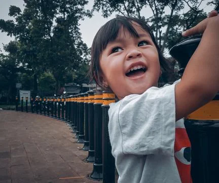 Asian little girl playing in the playground cheerfully Stock Photos