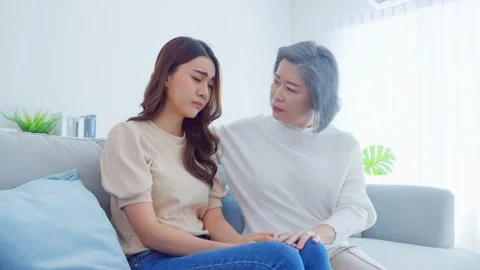 Asian loving elderly mother comforts upset daughter crying for problem. Stock Footage 170869858