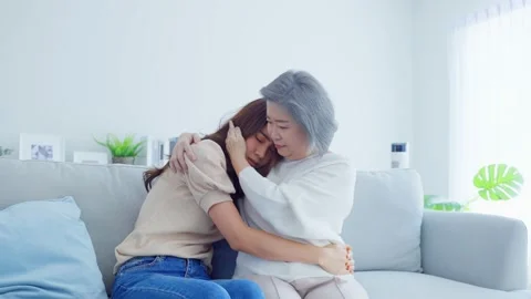 Asian loving elderly mother comforts upset daughter crying for problem. Stock Footage 171197322
