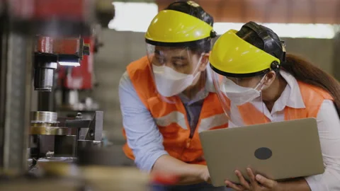 Asian machine engineer put on mask and face shield while working in industrial Stock Footage 146788838
