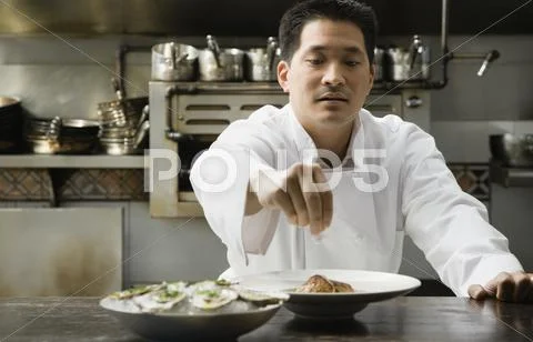 Asian Male Chef Seasoning Food