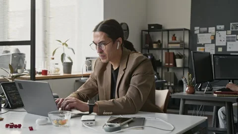 Asian Male Developer Coding on Laptop and Stretching in Office Stock Footage 336710903