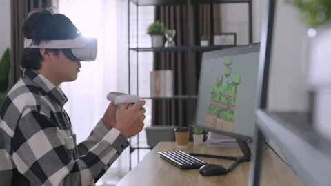 Asian male developer using computer to designer game at home. Stock Footage 220325632
