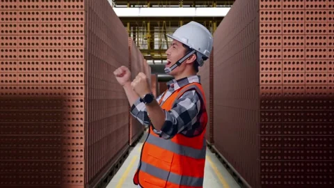 Asian Male Engineer Celebrating Working With Brick In Stacks Stock Footage 303759909