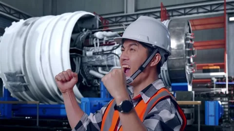 Asian Male Engineer Looking Around With Arms Akimbo With Jet Engine Stock Footage 306600766
