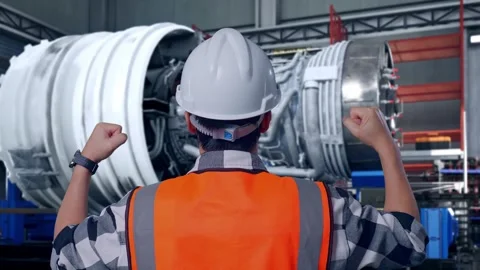 Asian Male Engineer Looking At Blueprint In His Hands With Jet Engine Stock Footage 306601482