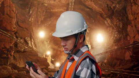 Asian Male Engineer Looking At The Tablet In His Hand In Mine tunnel Stock Footage 299571716