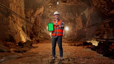 Asian Male Engineer Looking At The Tablet In His Hand In Mine tunnel Stock Footage 299573012