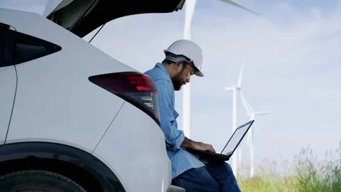 Asian male engineer sitting in the back of a car using a laptop Stock Footage 165042161
