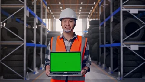 Asian Male Engineer Smiling And Showing Green Screen Laptop To Camera Tire Stock Footage 341786535