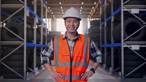 Asian Male Engineer Smiling To Camera Standing With Arms Akimbo Tire Warehouse Stock Footage 341786311
