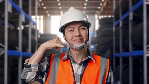 Asian Male Engineer Smiling To Camera And Making Call Me Gesture Tire Warehouse Stock Footage 341786891