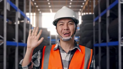 Asian Male Engineer Smiling To Camera And Waving Hand Saying Bye Tire Warehouse Stock Footage 341786935